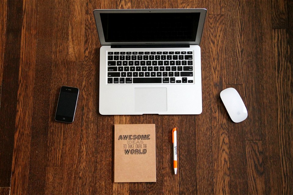 Macbook with iPhone & Journal on Wood Desk