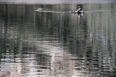 Fisherman on a Boat in the Lake photo
