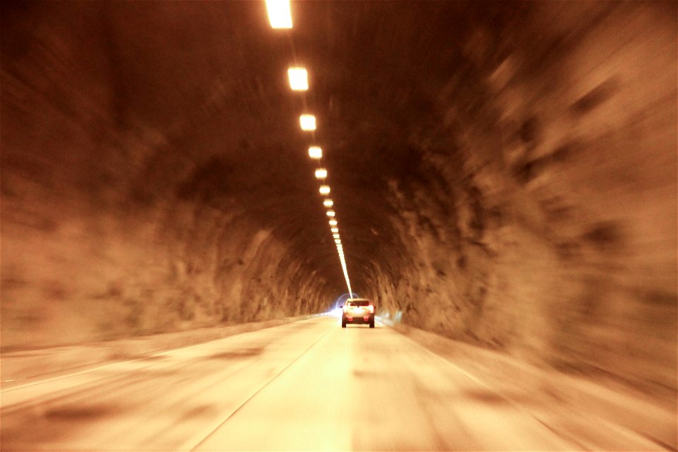 Car Drive Down Tunnel with Overhead Lights photo