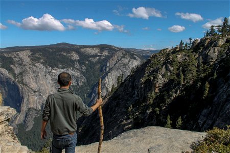 Man with Staff Looking at Mountains