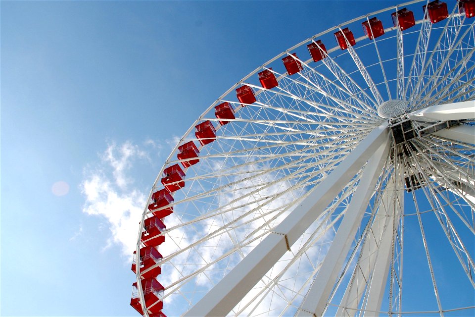 White & Red Ferris Wheel in Blue Sky with White Clouds