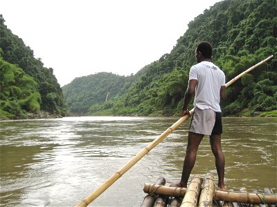 Man with Pole on Raft in River