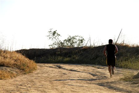 Man Running on Dirt Path photo