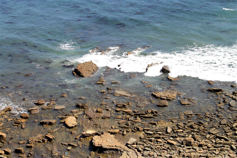Soft Ocean Waves on Beach Rocks photo