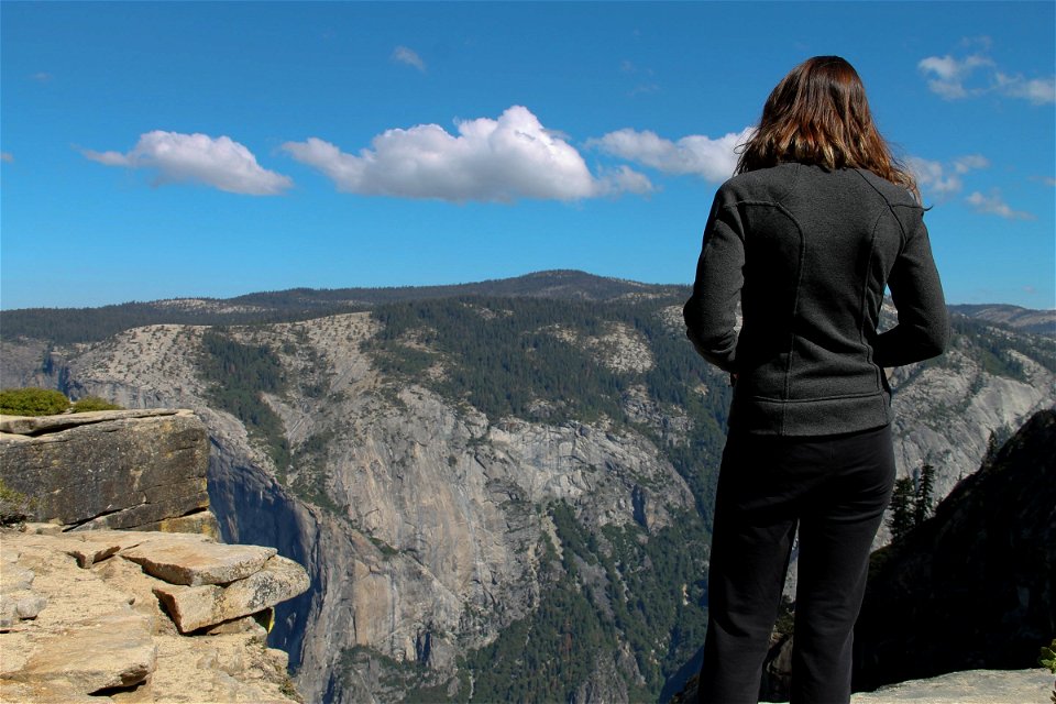 Woman on Cliffs Gazing at Mountains photo