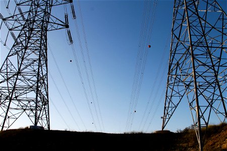 Electric Poles with Wires on Clear Blue Sky photo