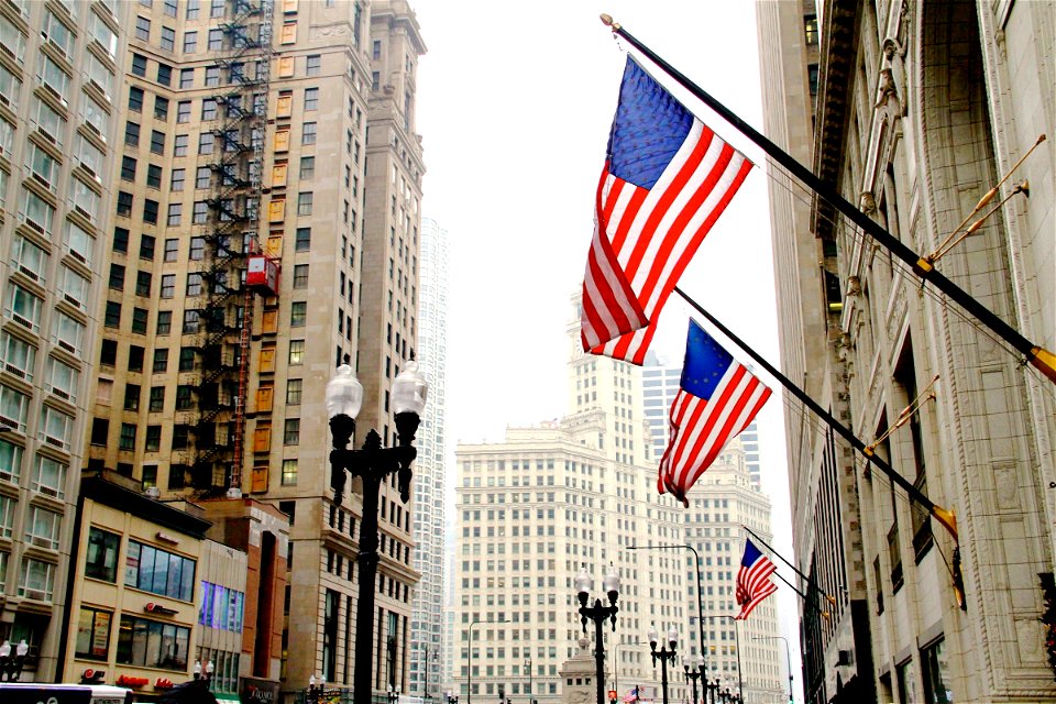 American Flags on Side of Building in City photo
