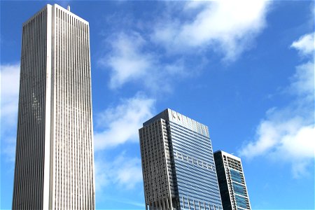 3 Tall Buildings in Sky with Clouds photo