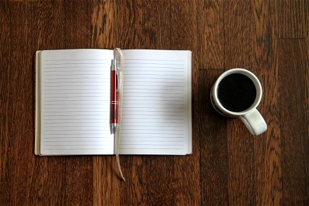 Blank Open Notebook & Coffee on Desk photo