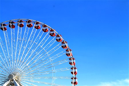 Red & White Ferris Wheel on Blue Sky photo