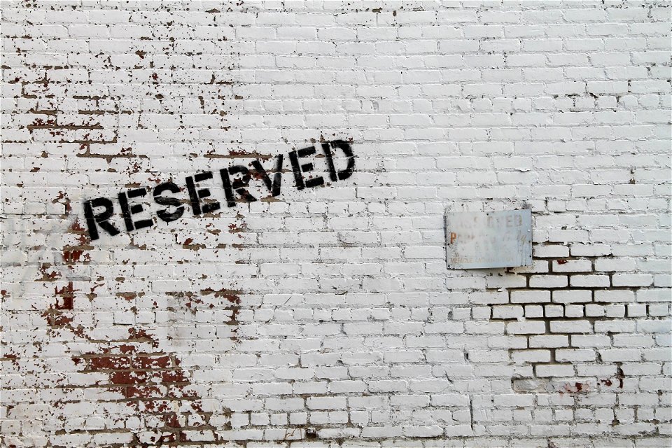 RESERVED Painted on White Brick Wall