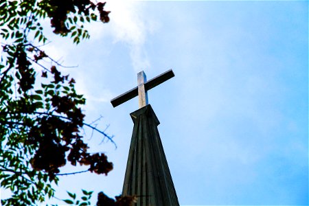 Cross on Church Steeple on Blue Sky photo