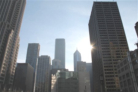 Tall Skyscrapers with Sun in Clear Sky photo