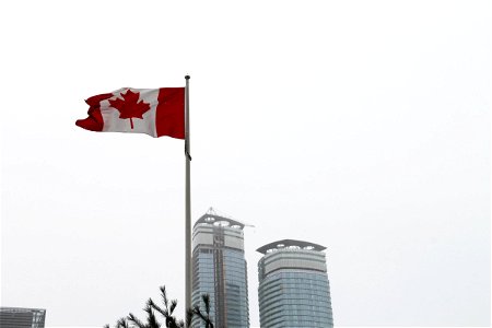 Canadian Flag Pole on Overcast Sky photo