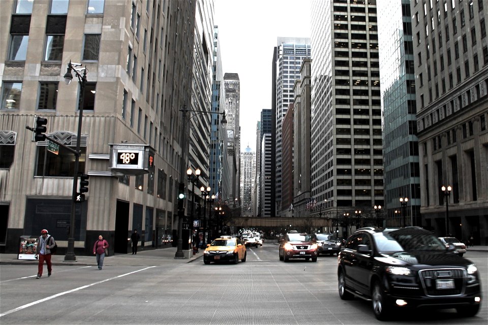 Cars Approaching on Busy Street in City photo