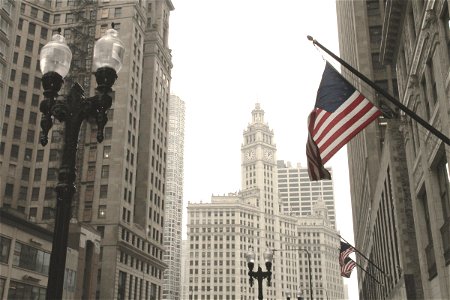 American Flag & Lamp Post in Front of Tall Buildings photo