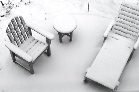 Patio Chairs & Table Covered in Snow photo