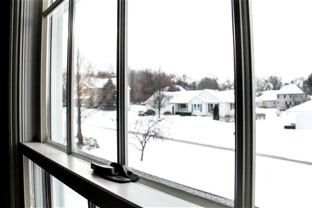Snow-Covered Neighborhood Street Through Window photo
