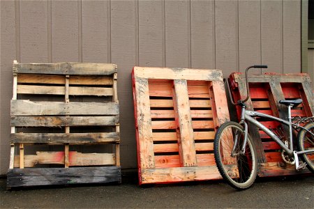 Old Bicycle Leaning Against Wood Pallets photo