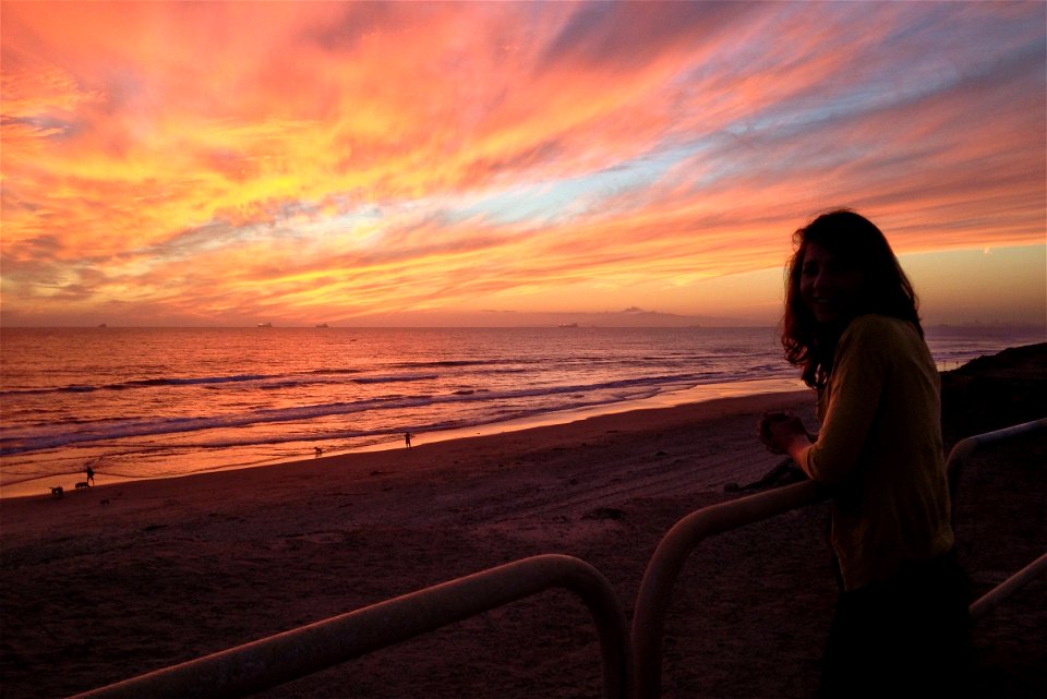 Woman at the Beach with Sunset Clouds