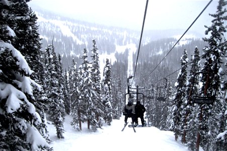 Ski Lift Going Up Snow Covered Mountain photo