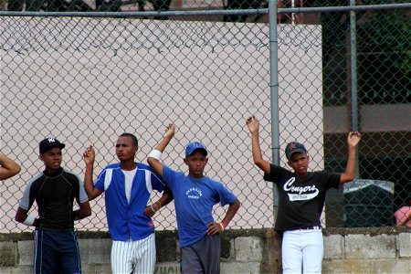 Teen Boys Baseball Players Leaning on Fence photo