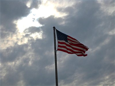 American Flag Waving on Cloudy Sky photo