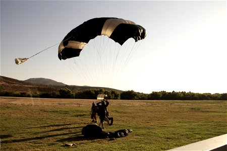 SkyDiver Parachute Landing in Field photo