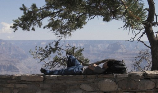 Man Lying on Wall Ledge photo
