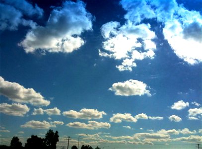 Puffy White Clouds in Blue Sky photo