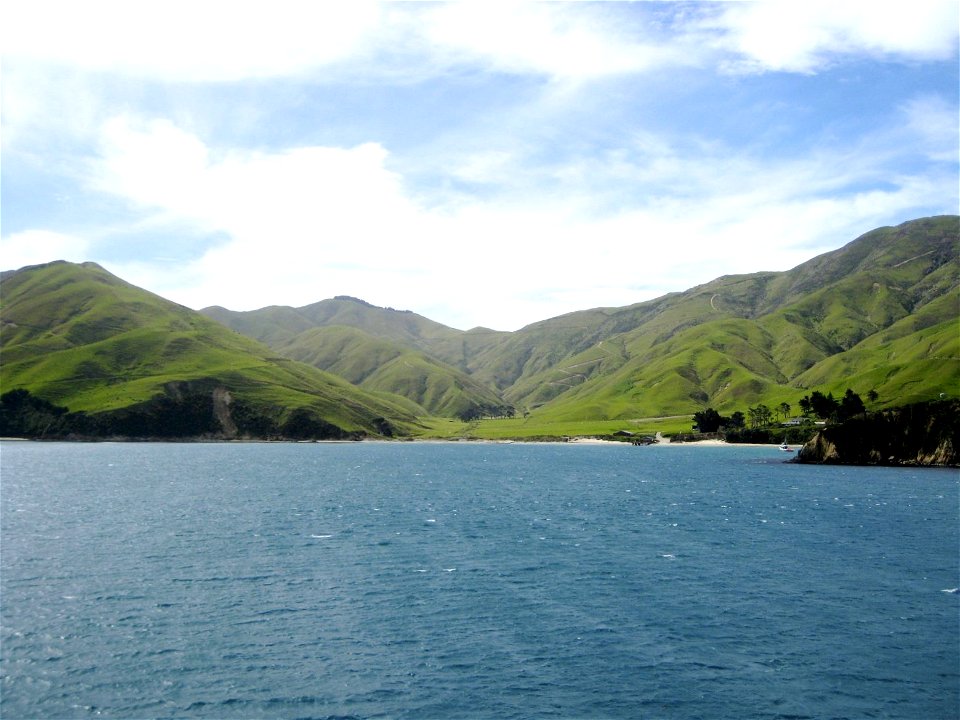Green Hills By Calm Water