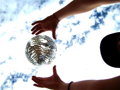Hands Over Suspended Silver Ball photo