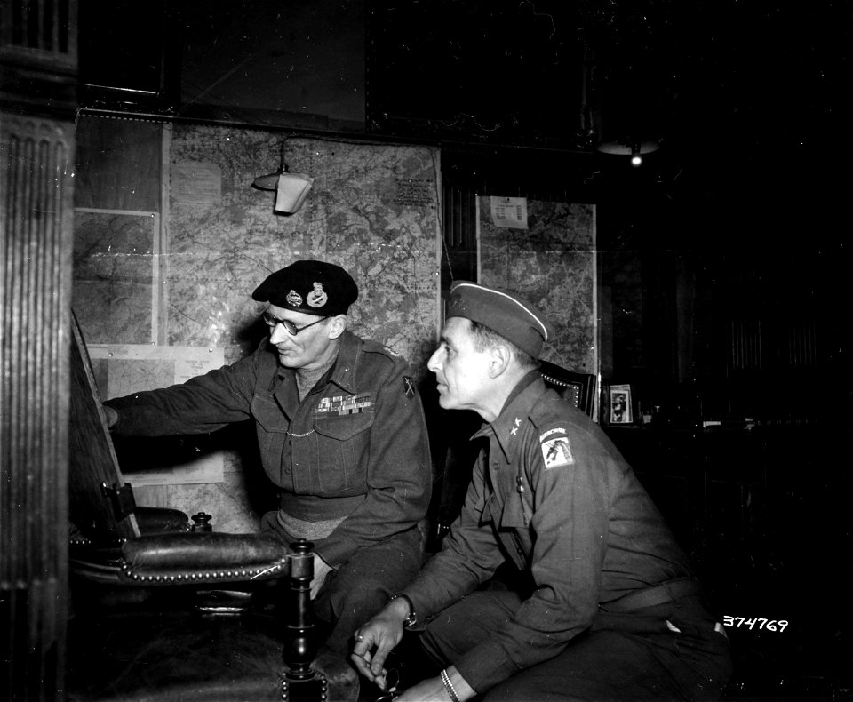 SC 374769 - Sir Bernard L. Montgomery, Commander in Chief of 21st Army Group, and Major General Matthew B. Ridgway, Commanding General of the XVIII Corps, Airborne, check situation maps. 12 January, 1945.