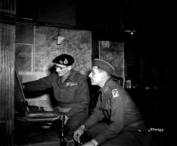 SC 374769 - Sir Bernard L. Montgomery, Commander in Chief of 21st Army Group, and Major General Matthew B. Ridgway, Commanding General of the XVIII Corps, Airborne, check situation maps. 12 January, 1945. photo