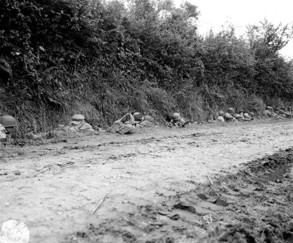 SC 270815 - G.I.'s hug the bank as Jerry shells drop close by near Marigny. 25 July, 1944.