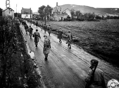 SC 195661 - 3rd Bn., 15th Inf. marching in wet clothes along winding road. photo