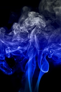 Thick blue smoke on black photo