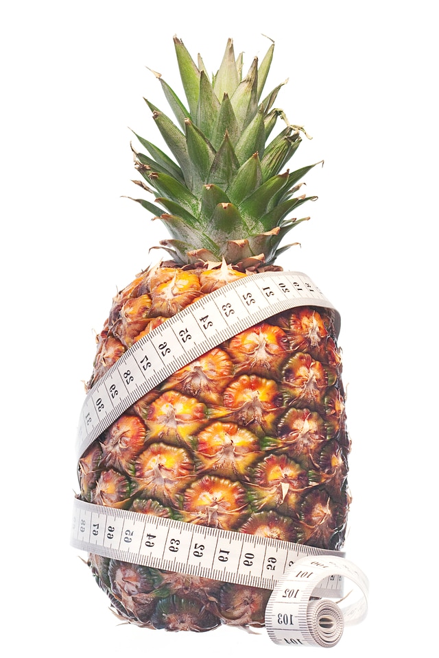 Pineapple with measuring tape losing weight
