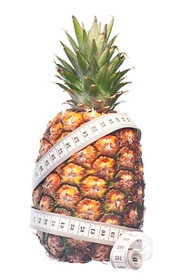 Pineapple with measuring tape losing weight
