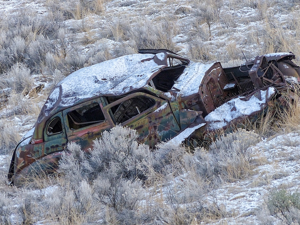Rusty car snow covered