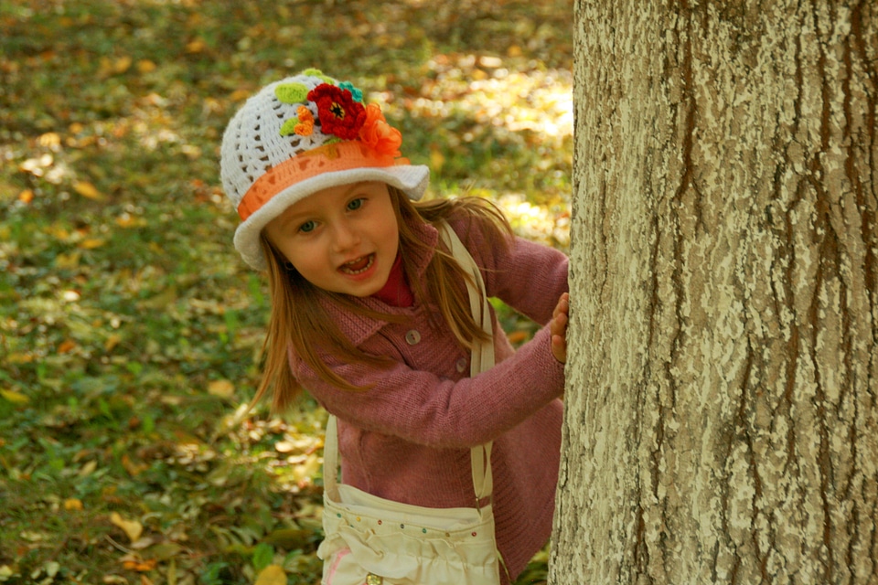Girl behind the tree
