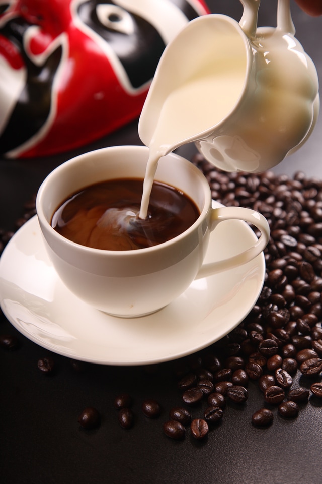 Cup of coffee pourring creme
