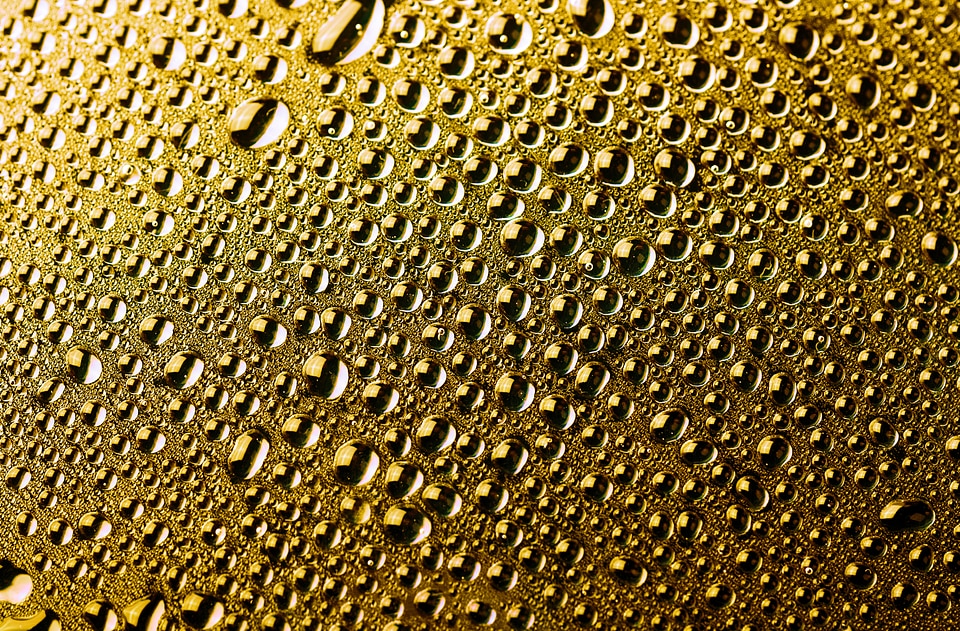 Water droplets golden background