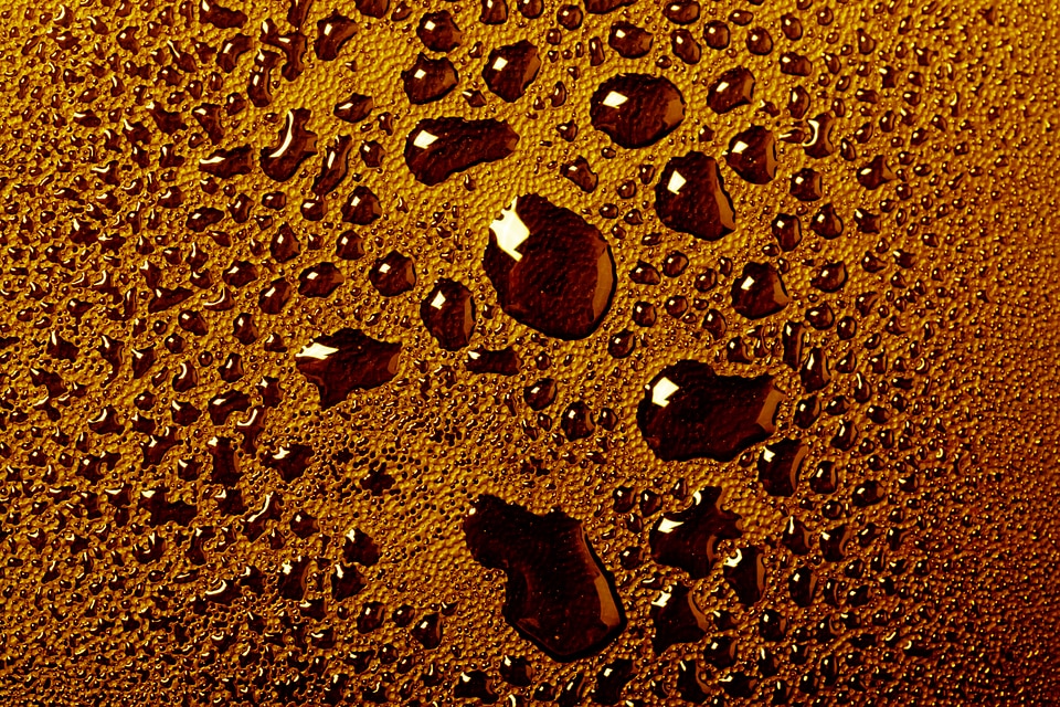Orange water drops macro background