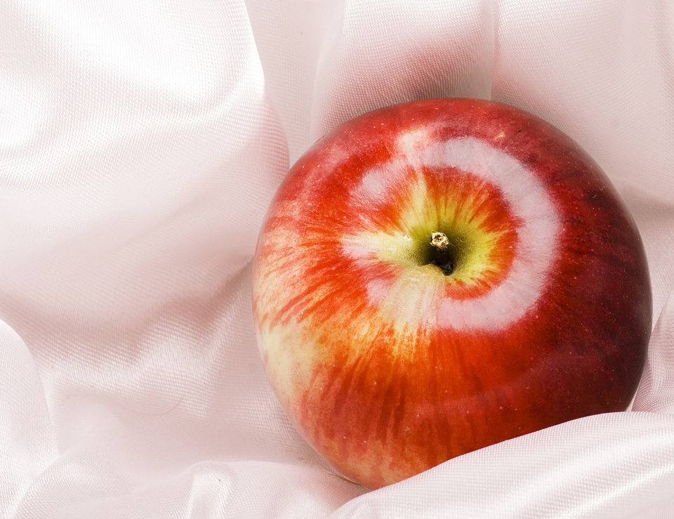 Red Apple on White Cloth