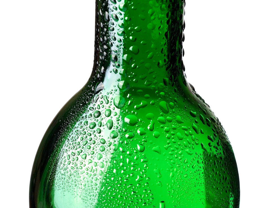 Closeup of green bottle with water drops