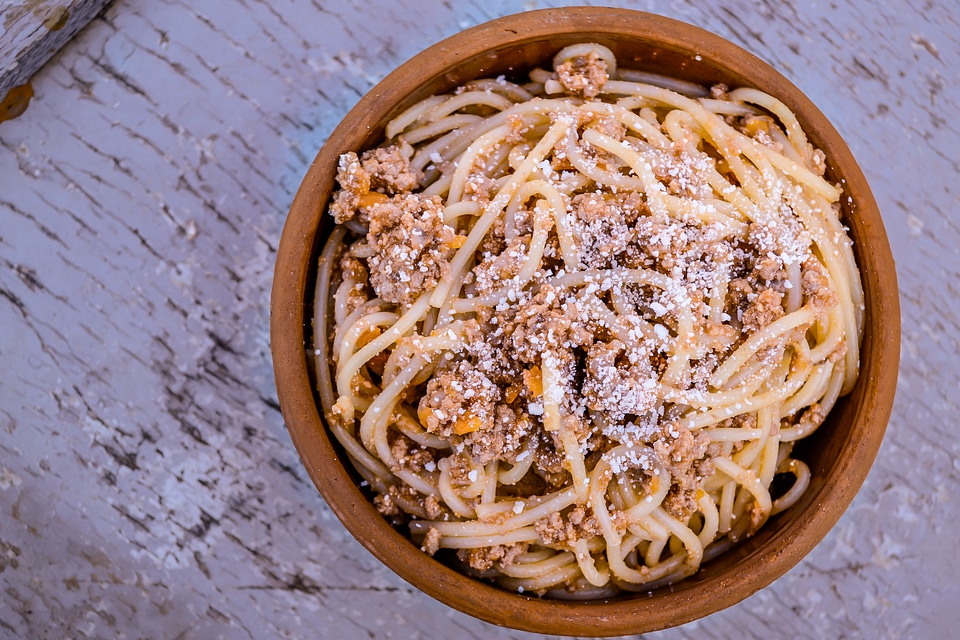 Pasta Bowl with Bolognese on a Cracked Paint Wood