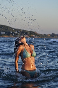 Woman Splashing Water in the Sea photo