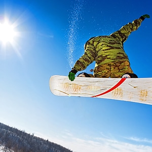 Snowboarder jumping photo