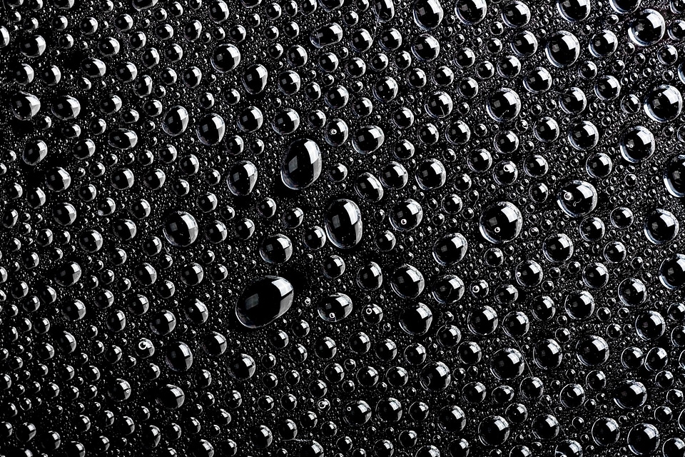 Black water drops macro background